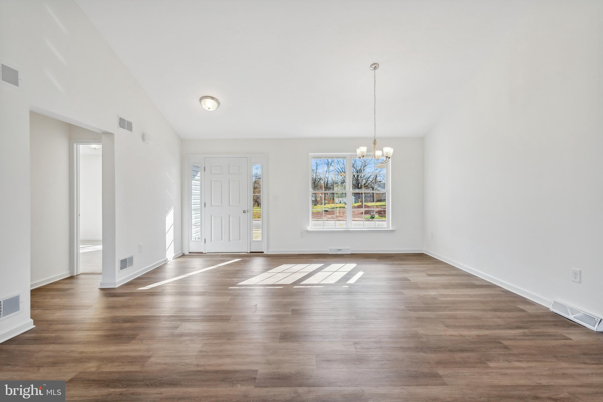170 Piedmont Way, Unit 98 Hanover, PA 17331 - Photo 6 of 23 a view of an empty room with window and wooden floor