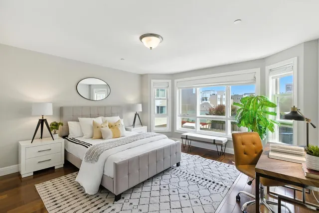 a bedroom with a bed a table and chair