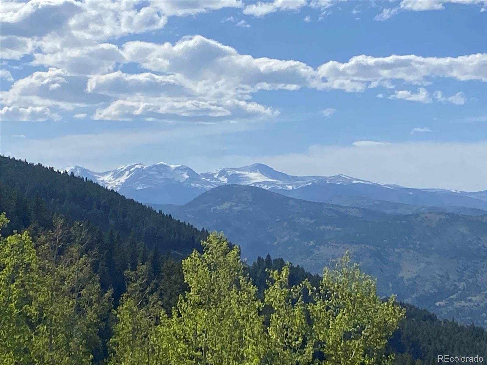 1695 Packsaddle Trail Evergreen, CO 80439 - Photo 4 of 7 an aerial view of houses covered in trees