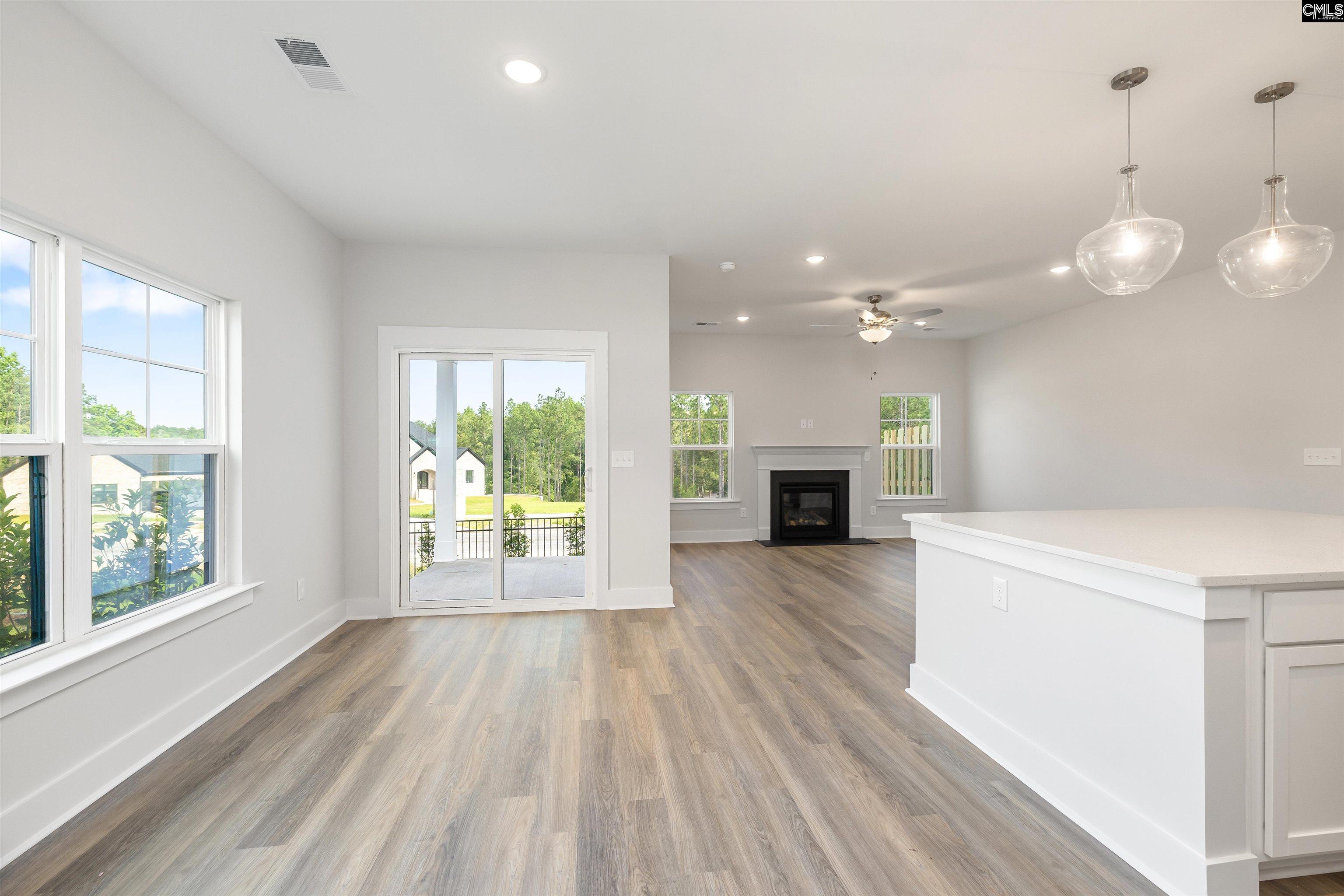 32 Fawn Spot Court Elgin, SC 29045 - Photo 6 of 28 a view of a room with wooden floors and fireplace