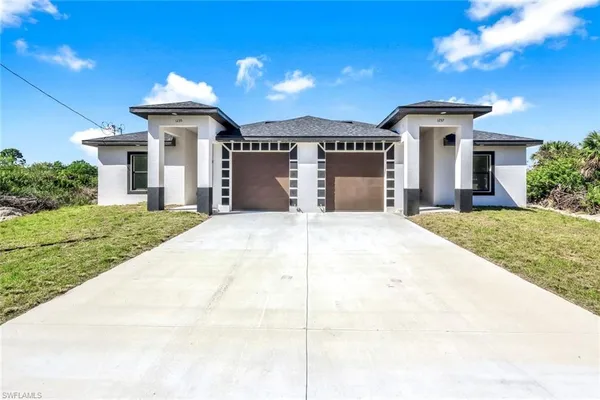 a front view of a house with yard