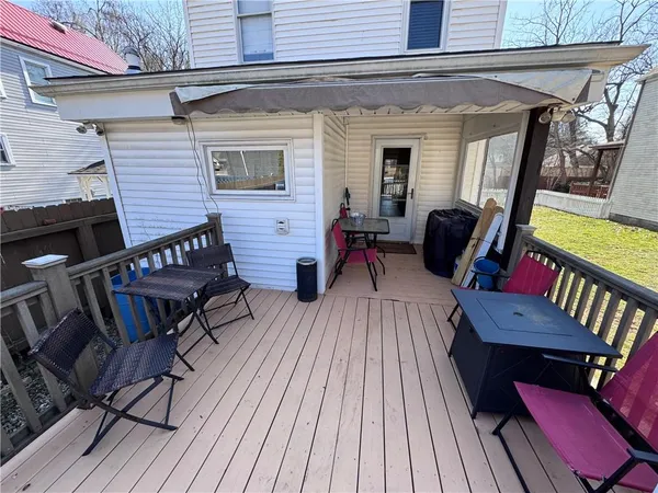 a view of a deck with table and chairs with wooden floor and furniture