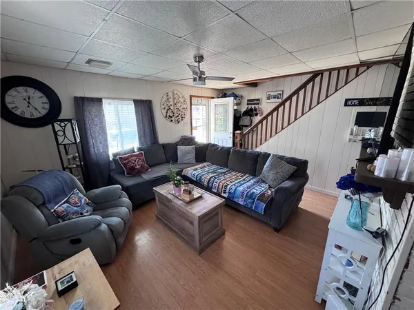 a living room with furniture a rug and a window