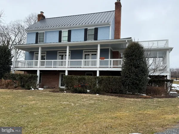 a front view of a house with lots of trees
