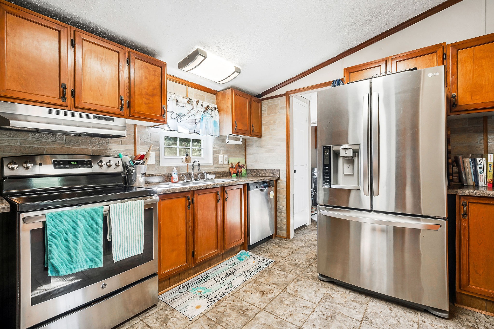 227 B A R Road Baxter, TN 38544 - Photo 7 of 52 a kitchen with stainless steel appliances granite countertop a refrigerator a stove and a sink with wooden floors