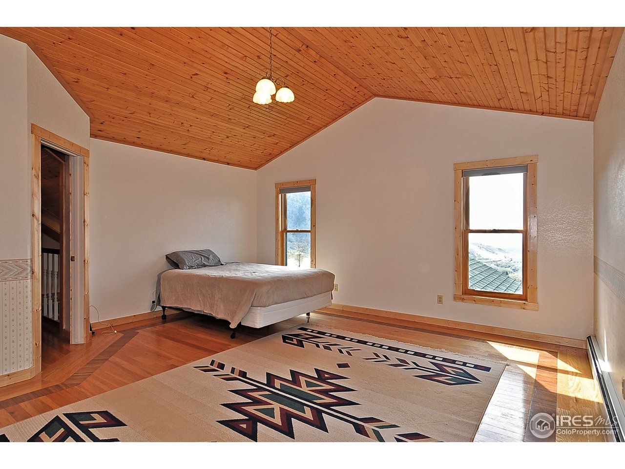439 Redtail Ridge Way Bellvue, CO 80512 - Photo 23 of 25 a bedroom with a bed and a window