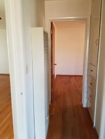 a view of a hallway with wooden floor