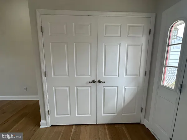 a view of an entryway with wooden floor