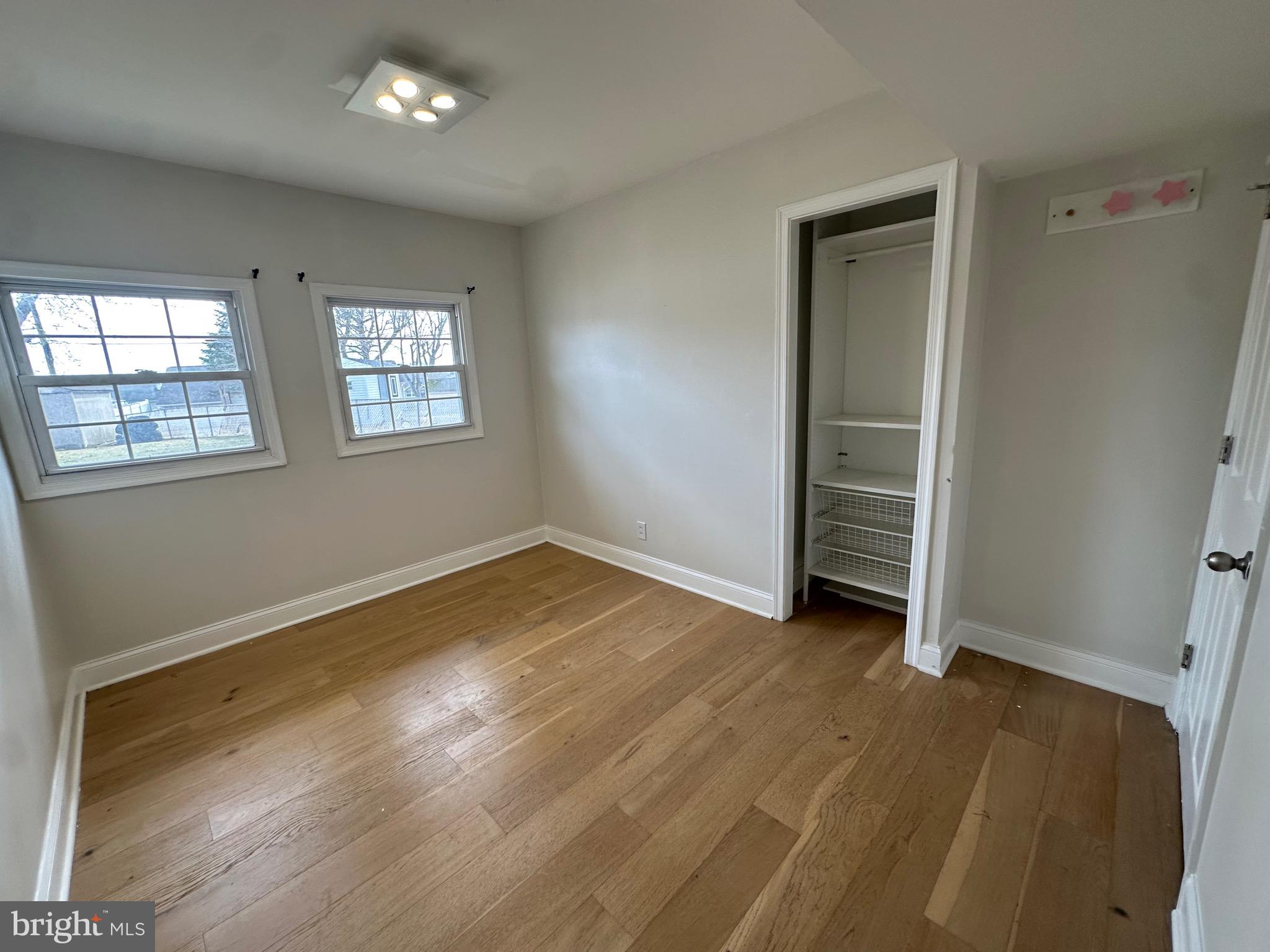 120 Lebbie Lane Fairless Hills, PA 19030 - Photo 18 of 25 an empty room with wooden floor and windows
