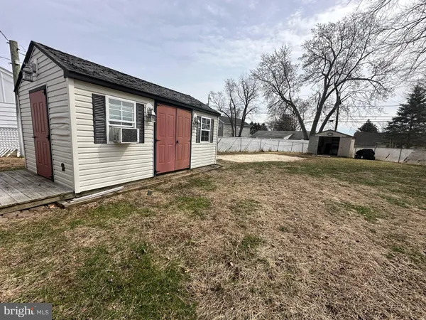 a backyard of a house with large trees