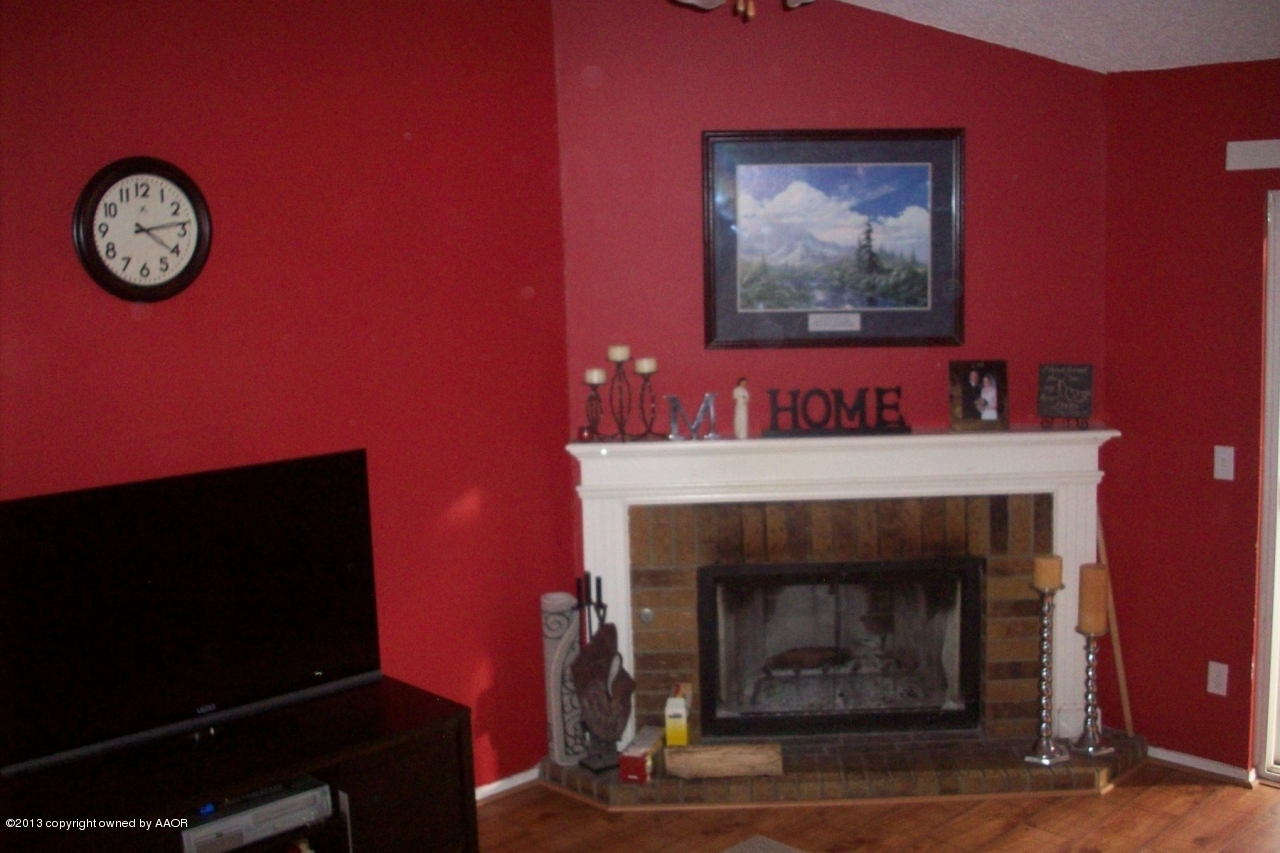 4203 Relatta Avenue Amarillo, TX 79110 - Photo 3 of 24 a living room with a fireplace and a flat screen tv