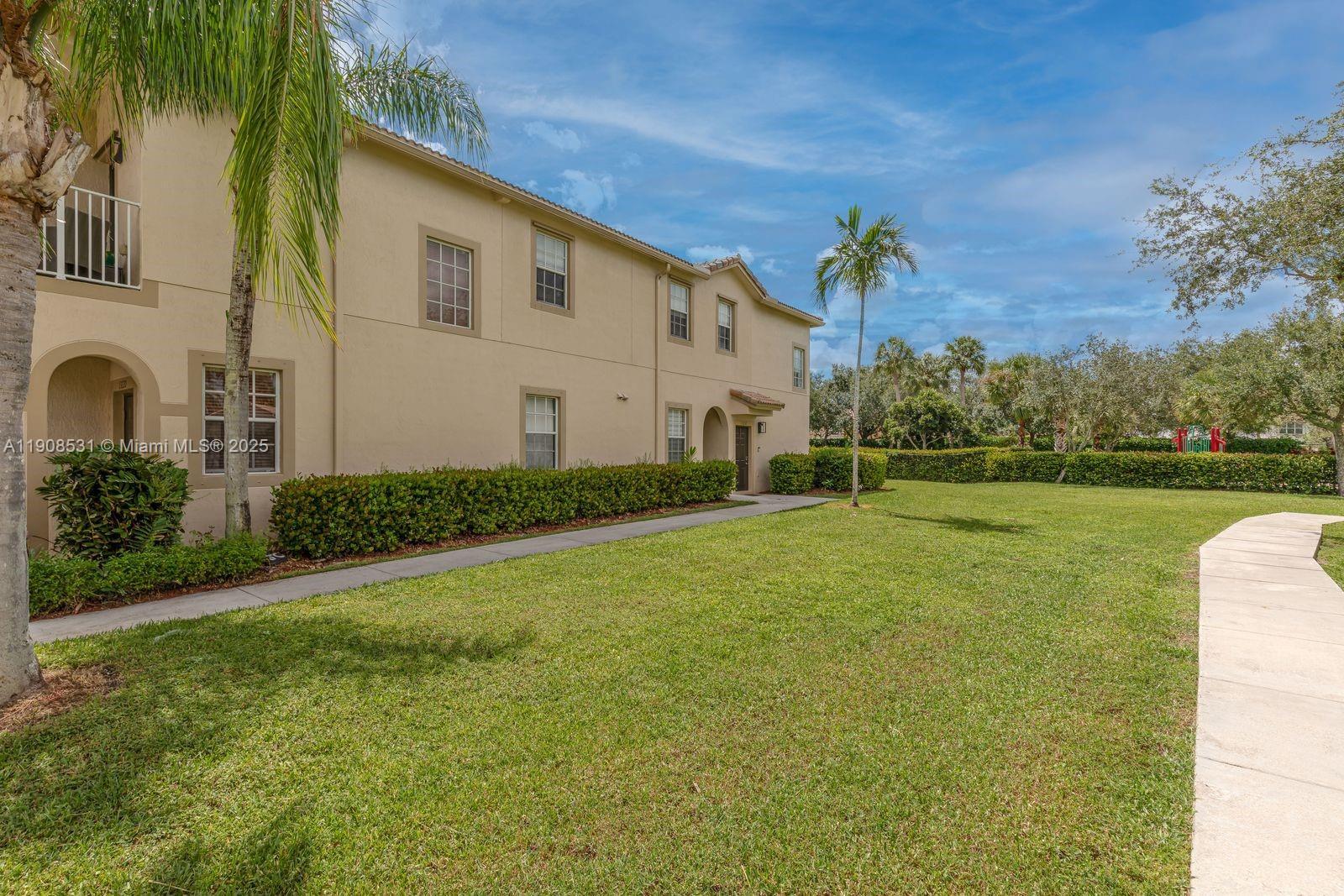 13216 Southwest 44th Street, Unit 11204 Miramar, FL 33027 - Photo 11 of 48 a front view of a house with garden
