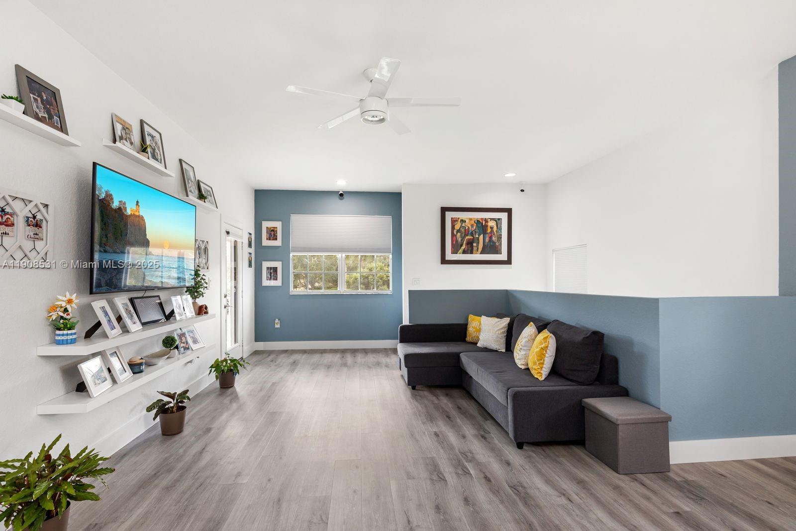 13216 Southwest 44th Street, Unit 11204 Miramar, FL 33027 - Photo 15 of 48 a living room with furniture and a flat screen tv