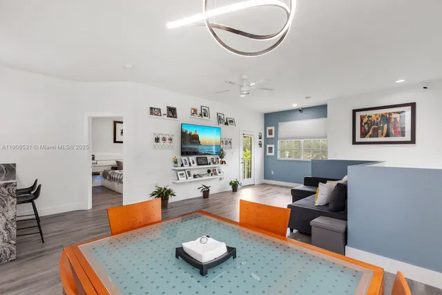 a living room with furniture and a wooden floor