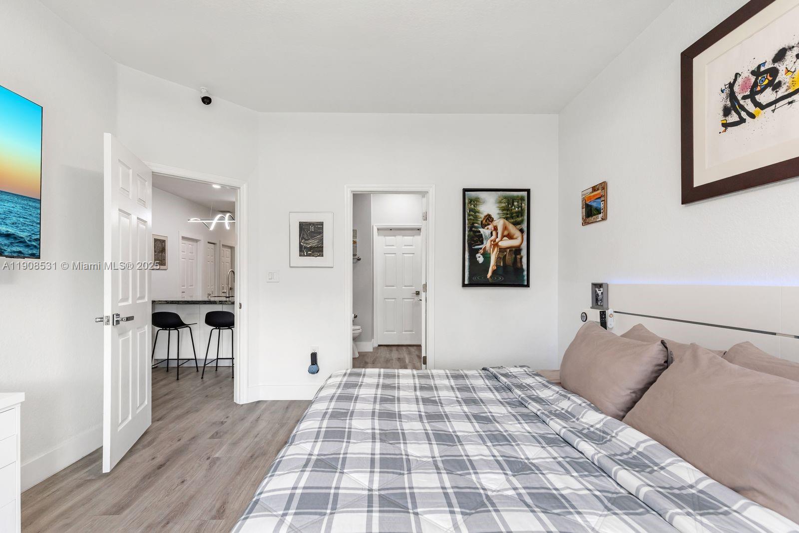 13216 Southwest 44th Street, Unit 11204 Miramar, FL 33027 - Photo 27 of 48 a bedroom with a bed and a table