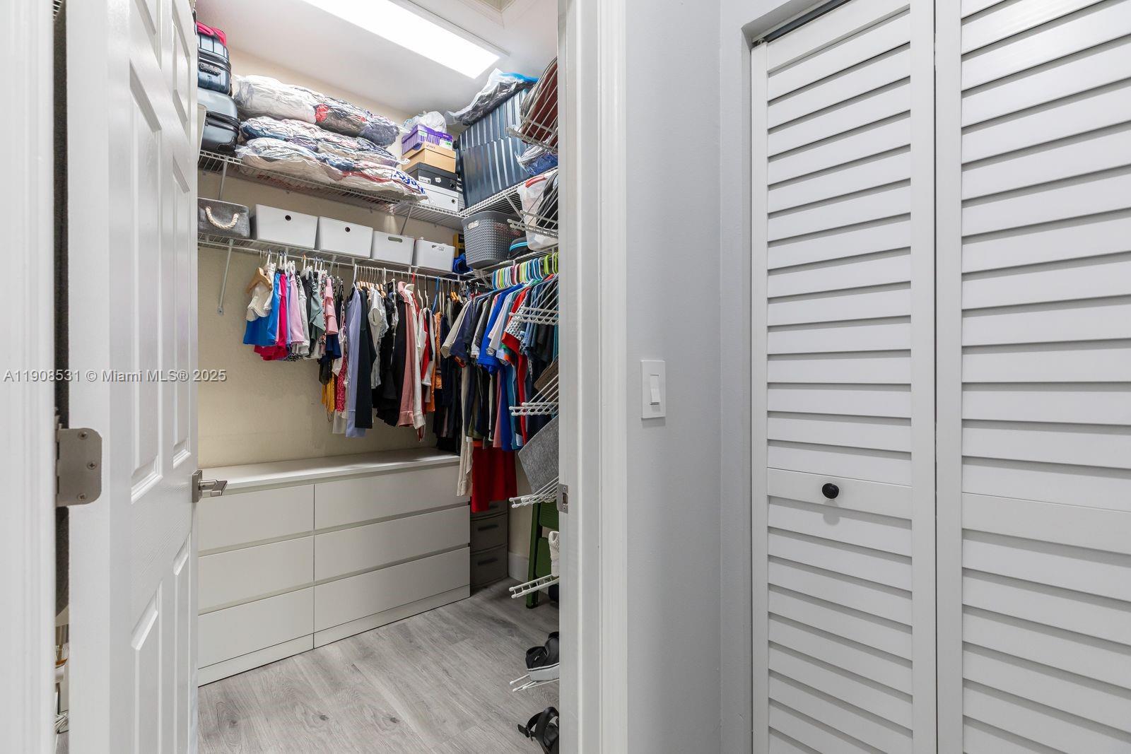 13216 Southwest 44th Street, Unit 11204 Miramar, FL 33027 - Photo 34 of 48 a view of walk in closet with clothes and shoes