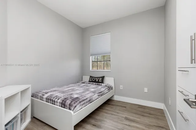 a bedroom with a bed and window