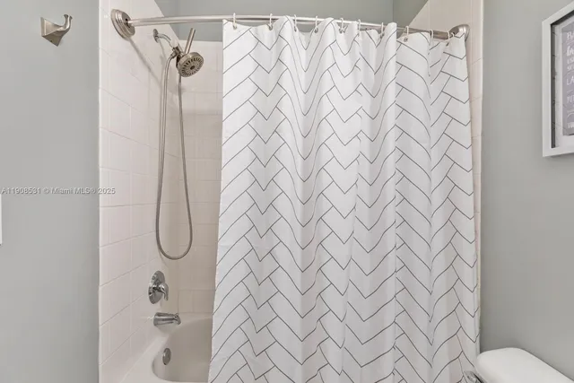 a bathroom with a shower curtain and a shower curtain