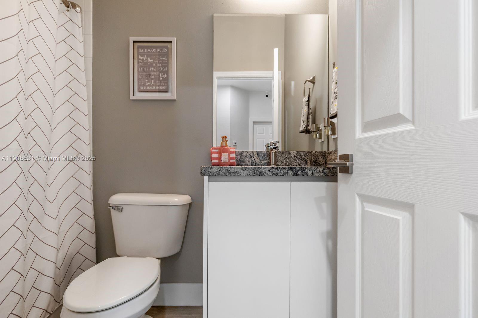 13216 Southwest 44th Street, Unit 11204 Miramar, FL 33027 - Photo 40 of 48 a white toilet sitting next to a bathroom sink