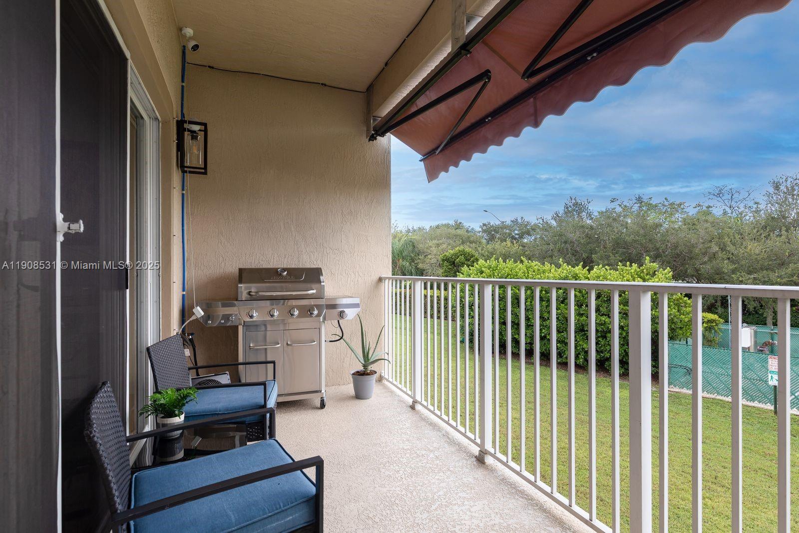 13216 Southwest 44th Street, Unit 11204 Miramar, FL 33027 - Photo 45 of 48 a balcony with furniture and a view of city