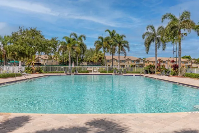 a backyard of a house with palm trees