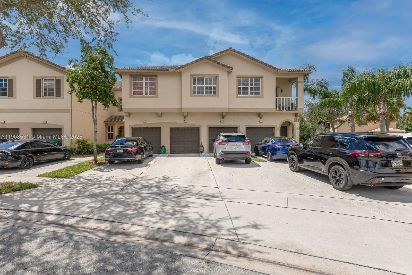13216 Southwest 44th Street, Unit 11204 Miramar, FL 33027 - Photo 10 of 48 a view of a car parked in front of a house