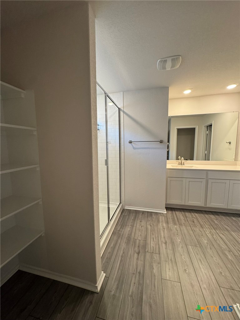 208 Ida Loop Seguin, TX 78155 - Photo 12 of 16 a view of a room with wooden floor and cabinet
