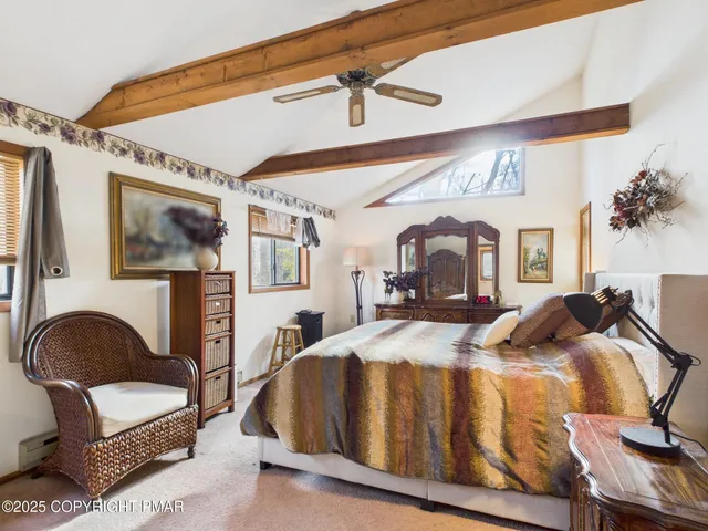 a bathroom with a tub a window and a shower