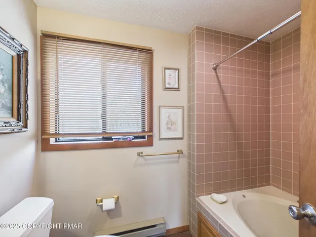 a bathroom with a bathtub and shower