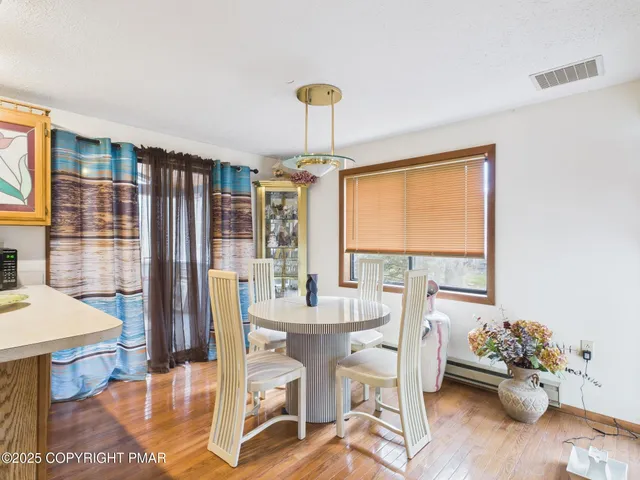 a dining room with furniture and window