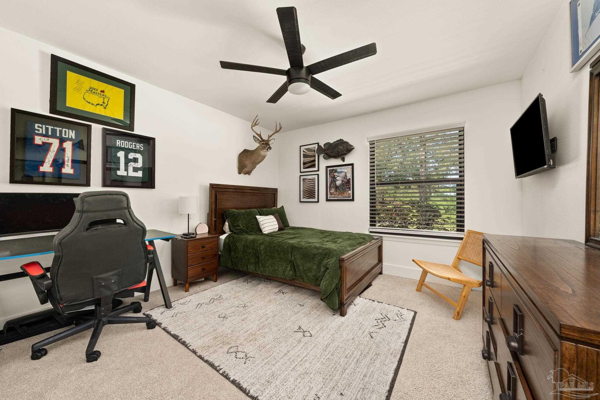 7716 Sunshine Hill Road Molino, FL 32577 - Photo 17 of 37 a living room with furniture and a flat screen tv