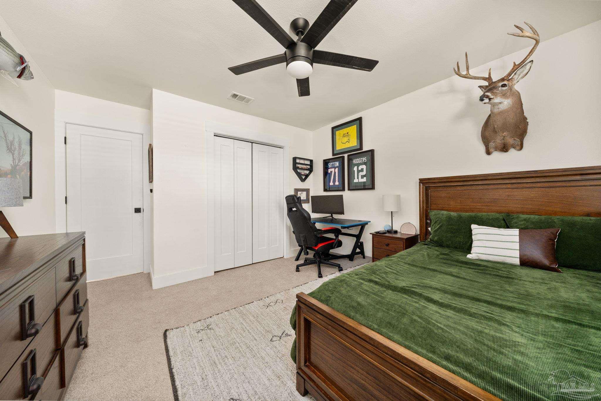 7716 Sunshine Hill Road Molino, FL 32577 - Photo 18 of 37 a bedroom with a bed and a chandelier