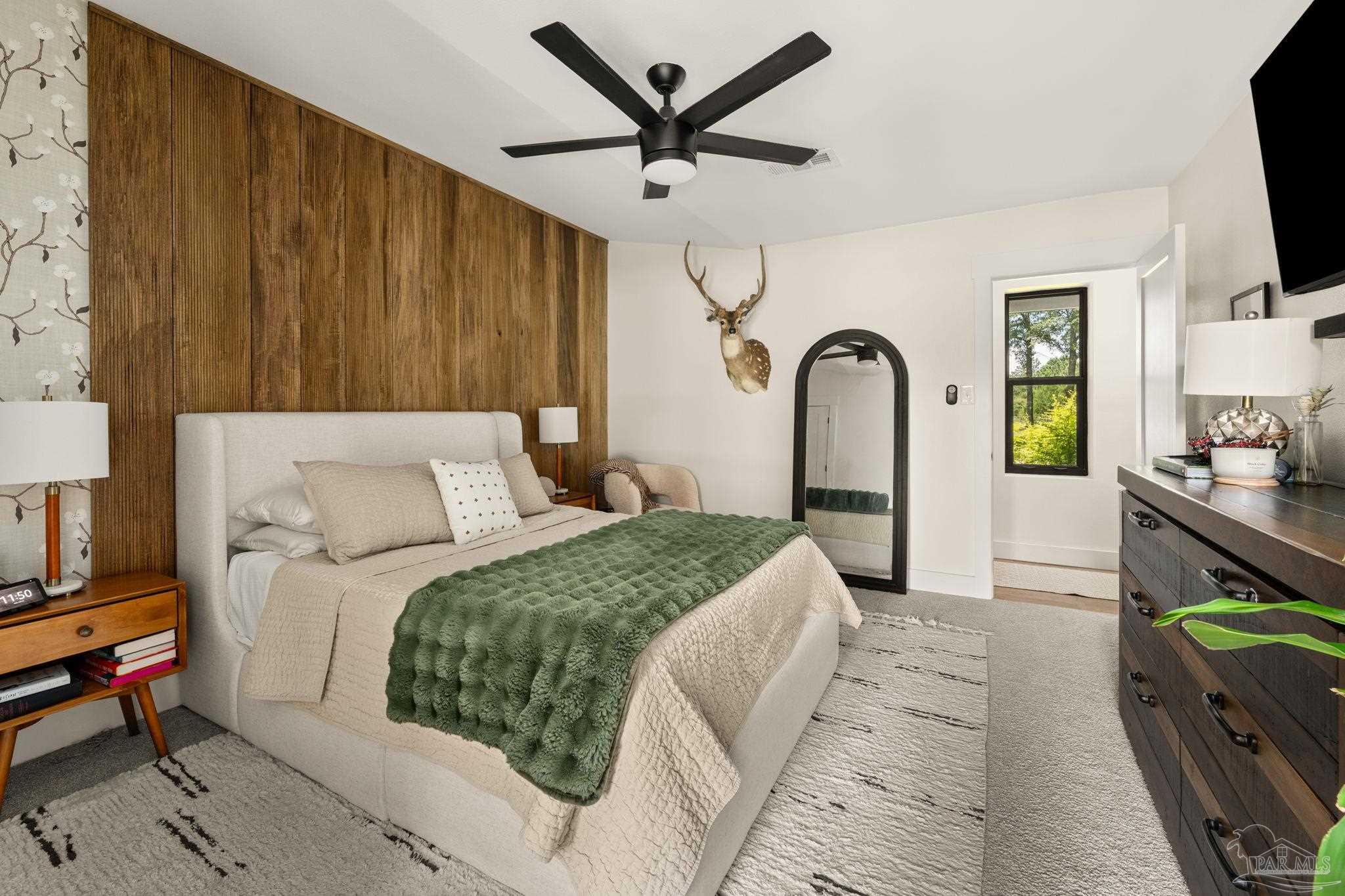 7716 Sunshine Hill Road Molino, FL 32577 - Photo 19 of 37 a bed room with a bed and a television