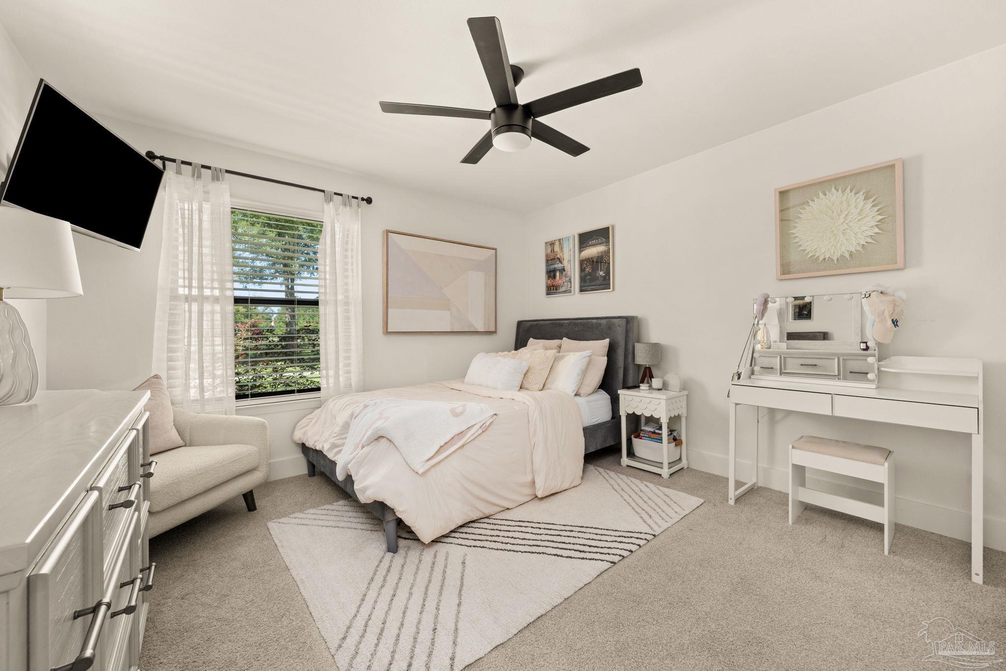 7716 Sunshine Hill Road Molino, FL 32577 - Photo 21 of 37 a bedroom with a bed a couch and a window