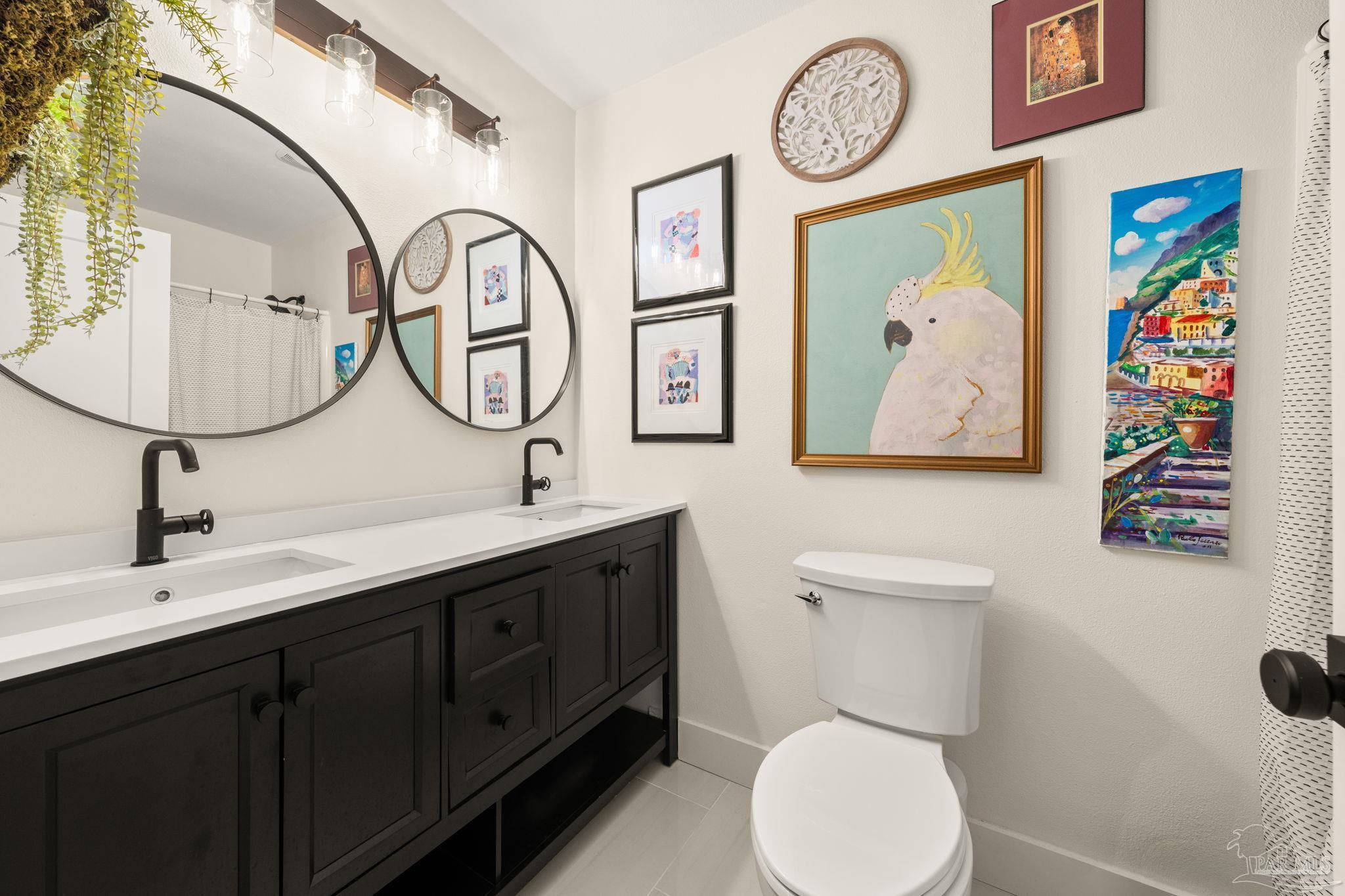 7716 Sunshine Hill Road Molino, FL 32577 - Photo 22 of 37 a bathroom with a toilet a sink and a mirror