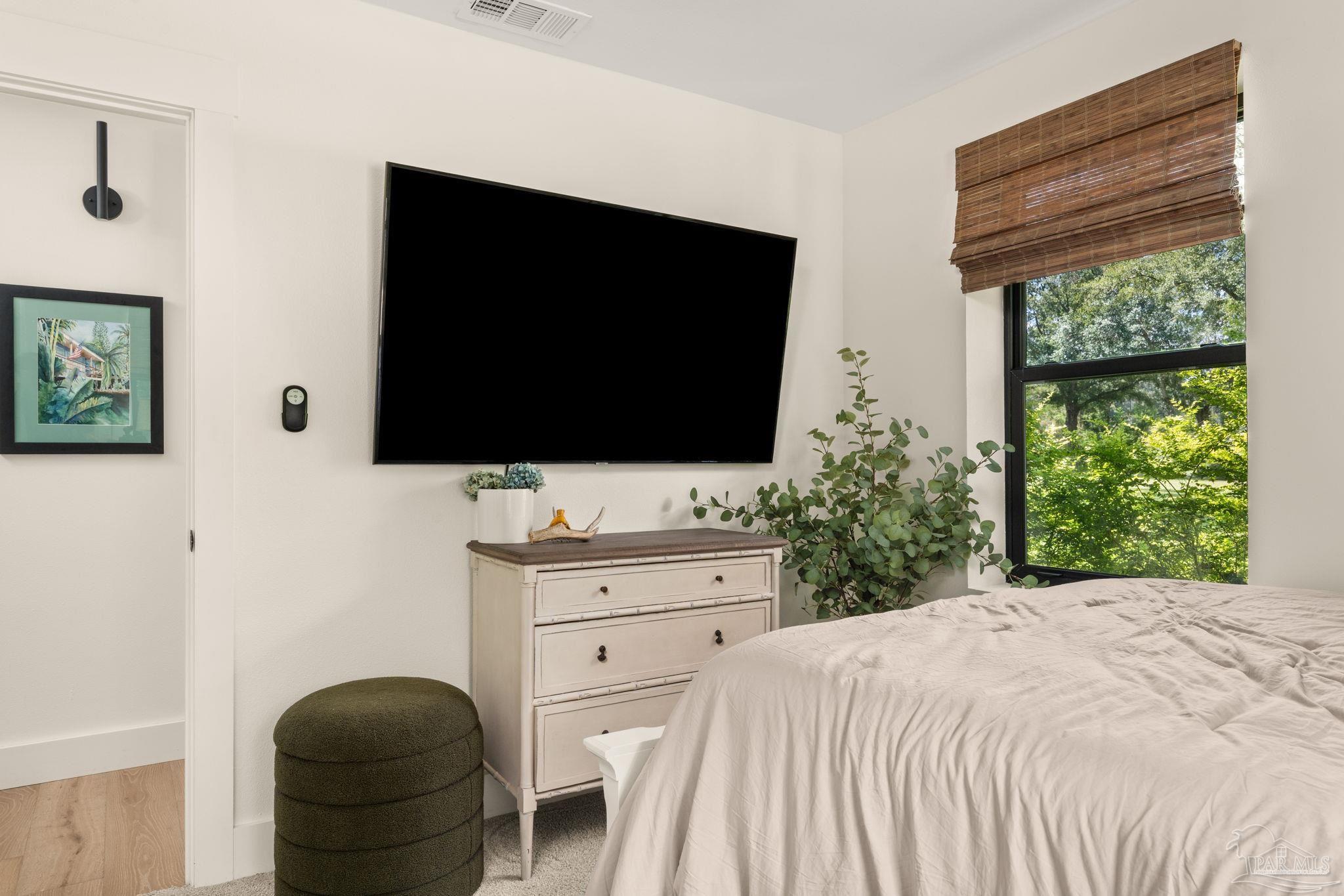 7716 Sunshine Hill Road Molino, FL 32577 - Photo 23 of 37 a bedroom with a bed and a flat screen tv