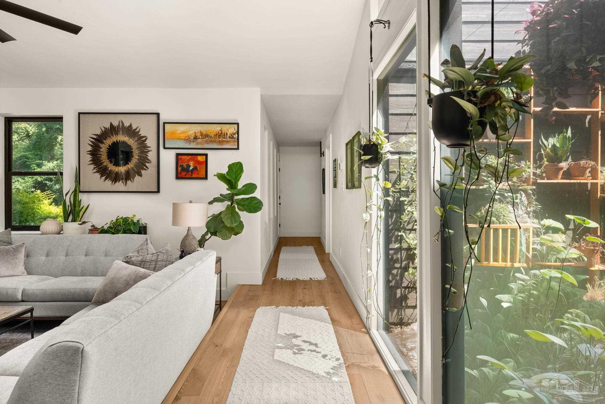 7716 Sunshine Hill Road Molino, FL 32577 - Photo 26 of 37 a living room with furniture and a floor to ceiling window