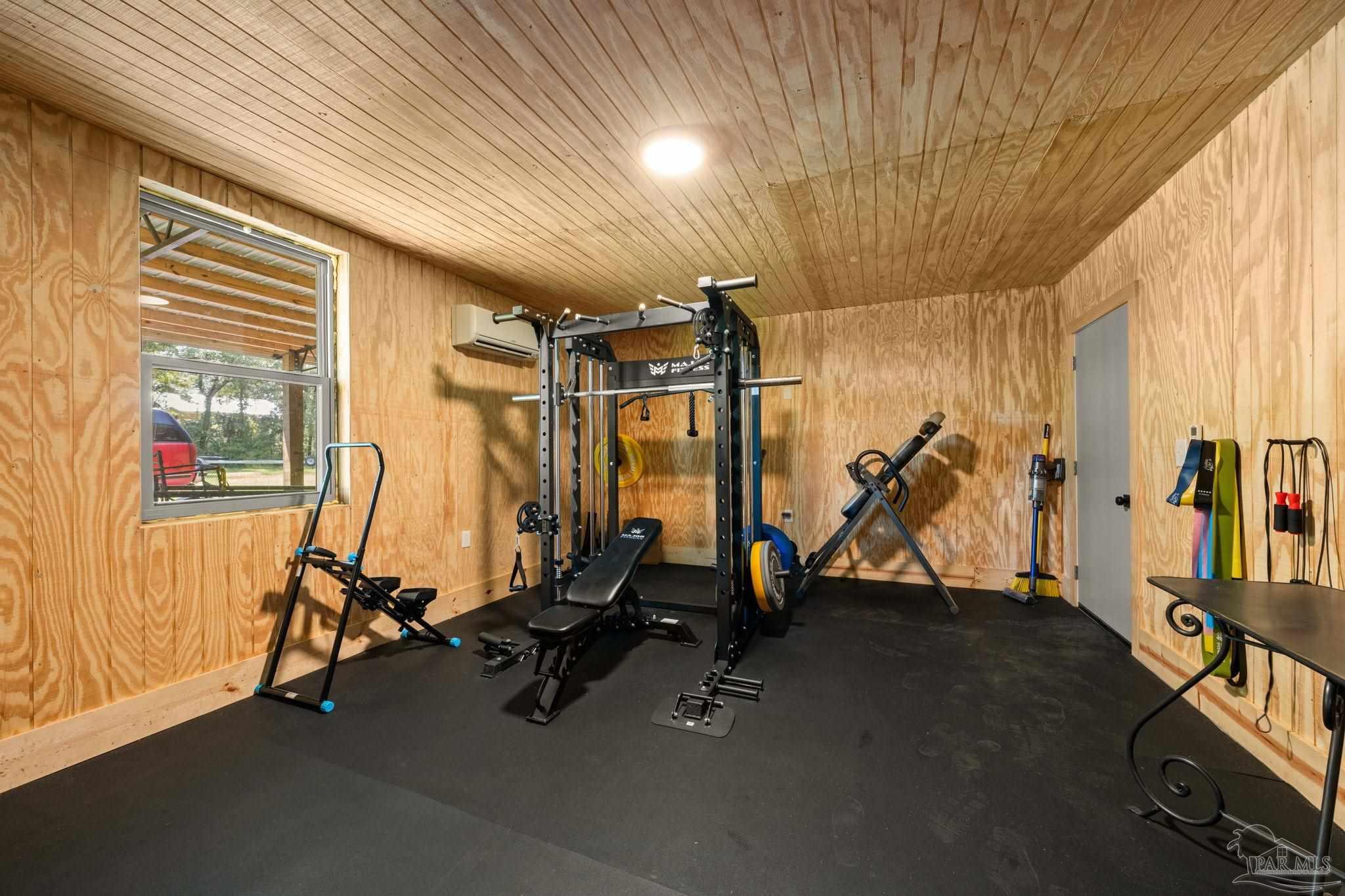 7716 Sunshine Hill Road Molino, FL 32577 - Photo 28 of 37 a view of a room with gym equipment