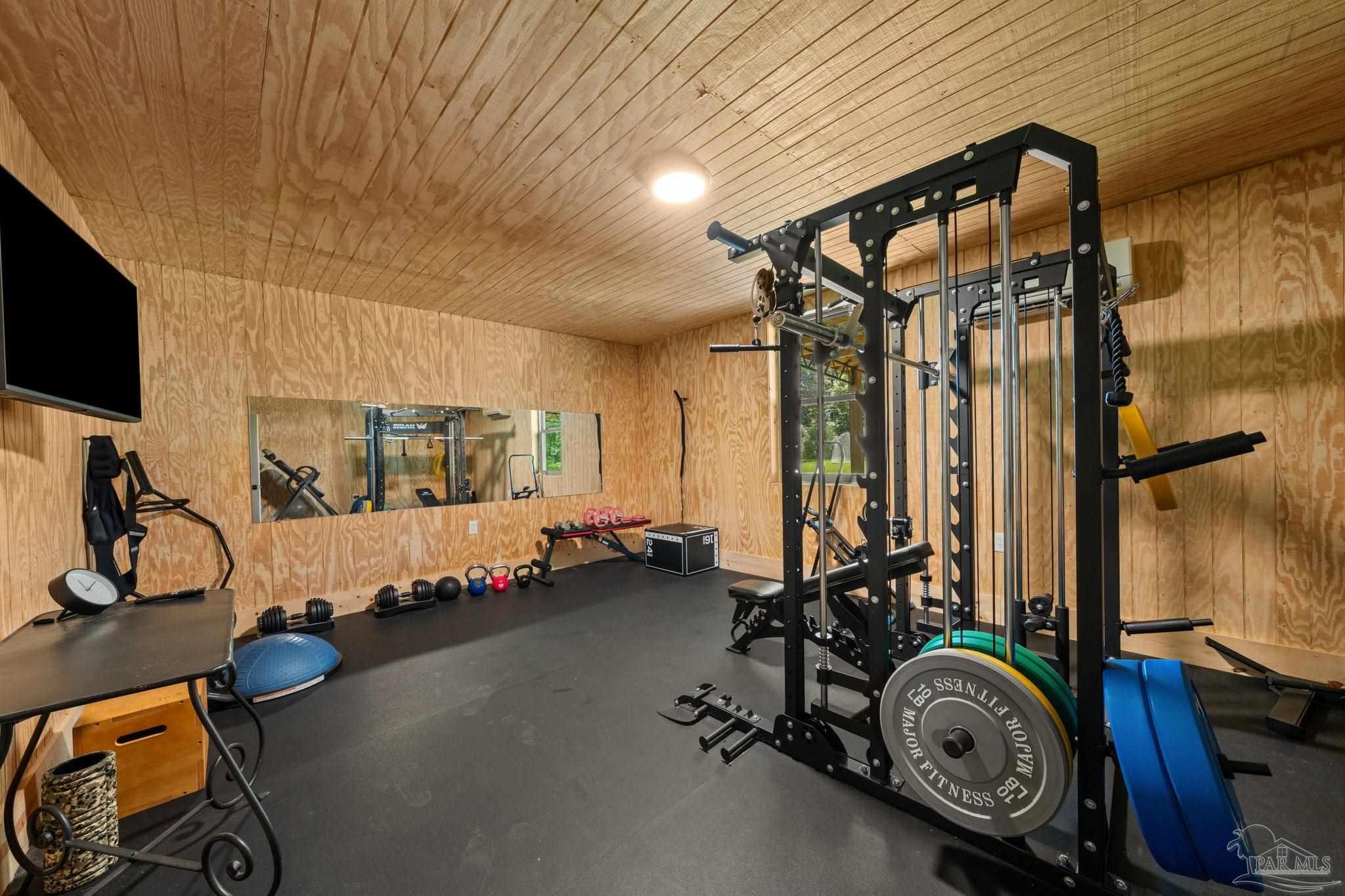 7716 Sunshine Hill Road Molino, FL 32577 - Photo 29 of 37 a view of a room with gym equipment