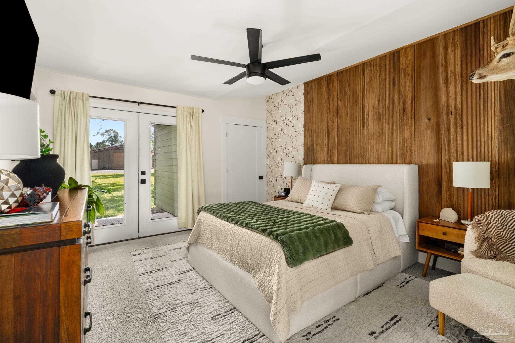 7716 Sunshine Hill Road Molino, FL 32577 - Photo 3 of 37 a bedroom with a bed and a flat tv screen