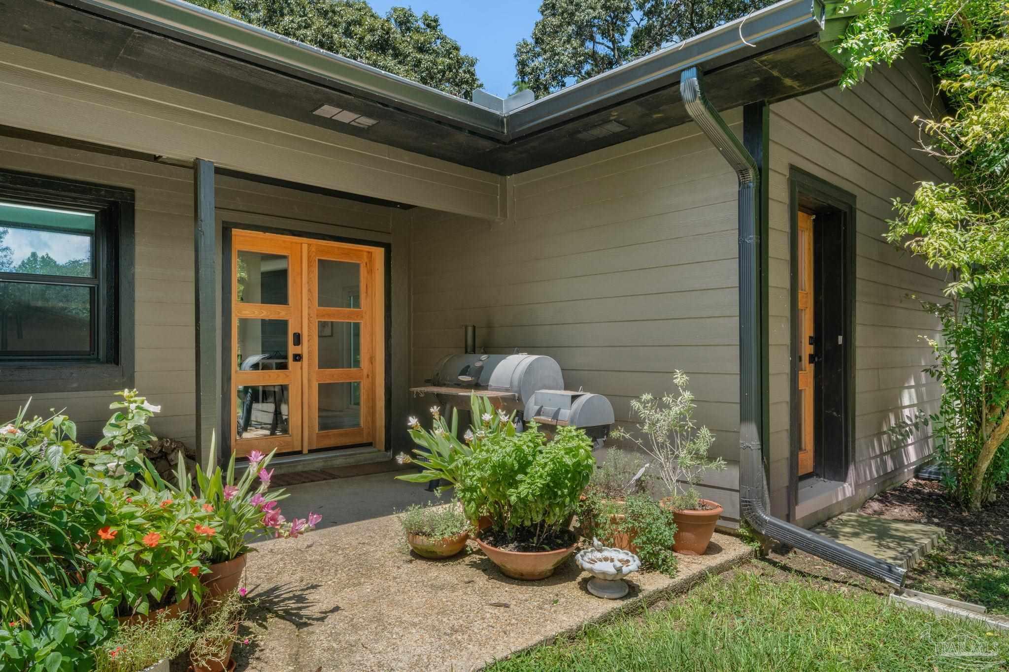 7716 Sunshine Hill Road Molino, FL 32577 - Photo 34 of 37 a potted plant sitting in front of a house