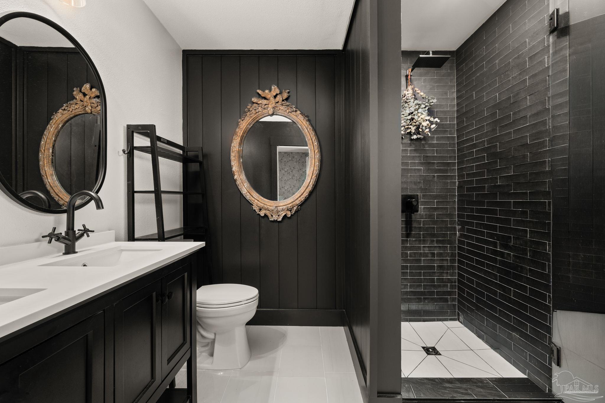 7716 Sunshine Hill Road Molino, FL 32577 - Photo 6 of 37 a bathroom with a sink a toilet and a mirror