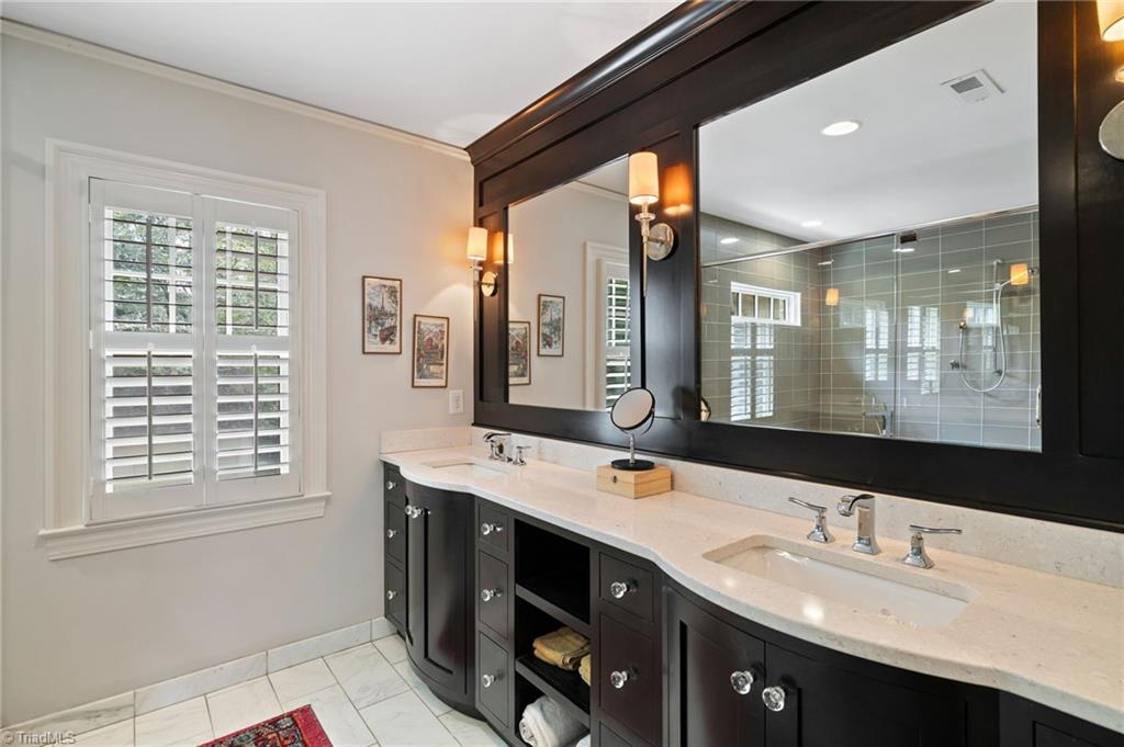 2105 Rolling Road Greensboro, NC 27403 - Photo 27 of 50 Primary bathroom with double sink and custom built-in mirrors