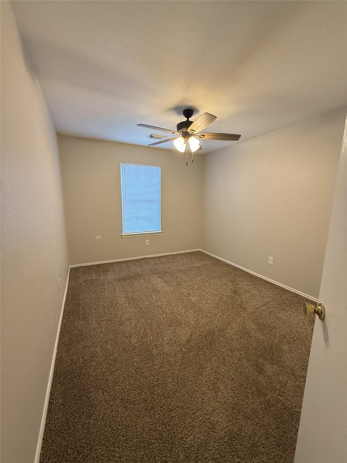 22819 Sugar Bear Drive Spring, TX 77389 - Photo 16 of 20 an empty room with a chandelier fan and windows