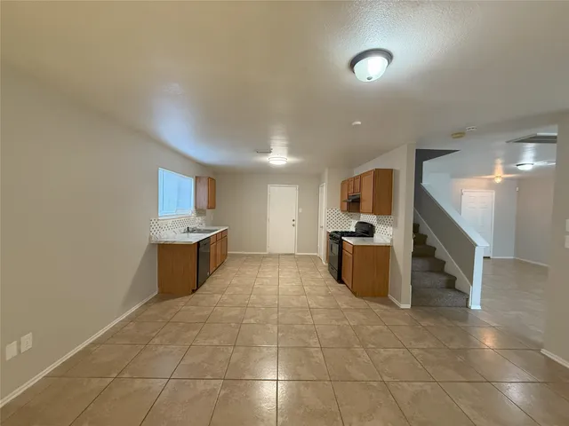 a large kitchen with a sink and counter space