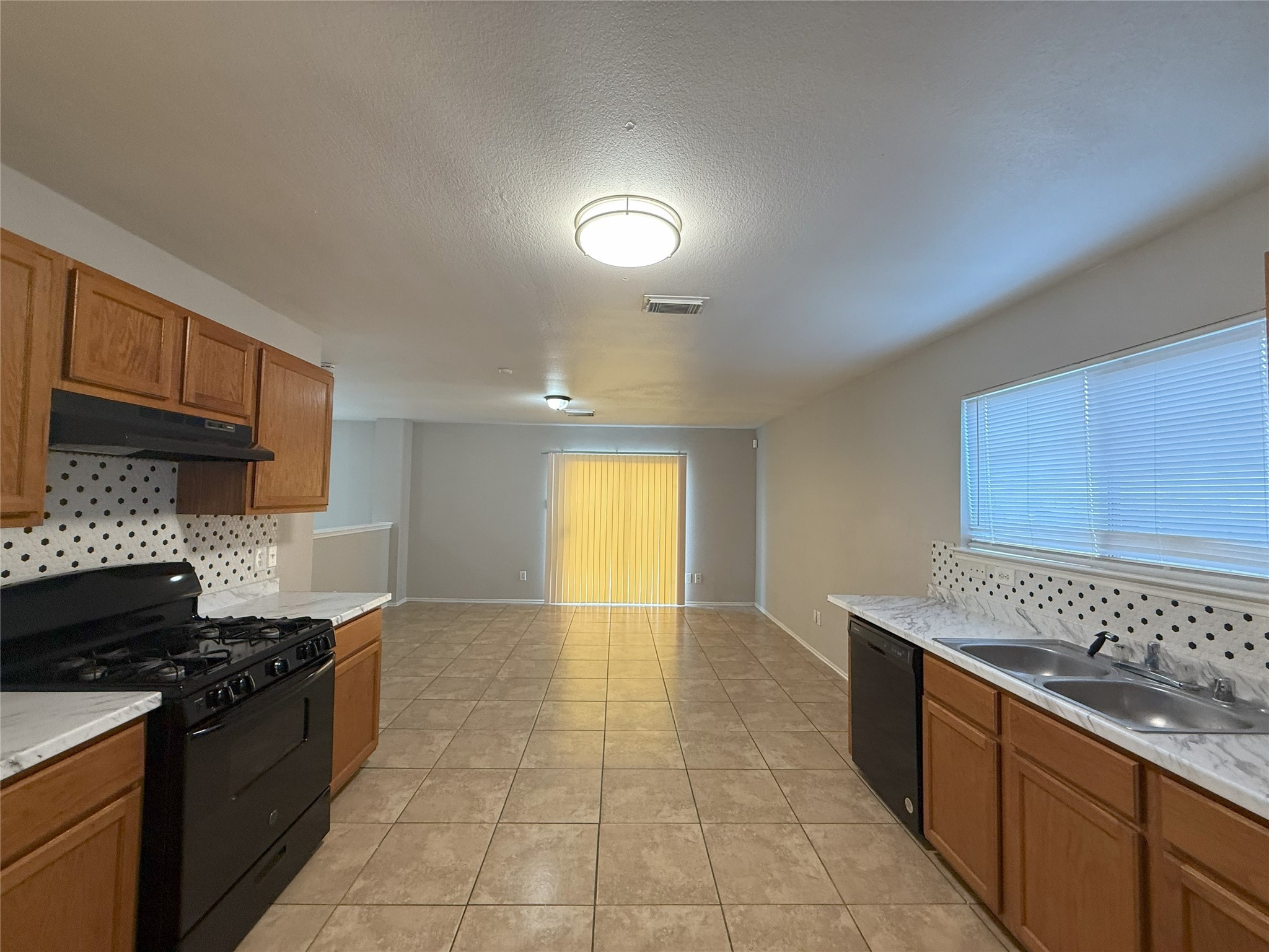 22819 Sugar Bear Drive Spring, TX 77389 - Photo 6 of 20 a kitchen with stainless steel appliances granite countertop a stove a sink and a microwave