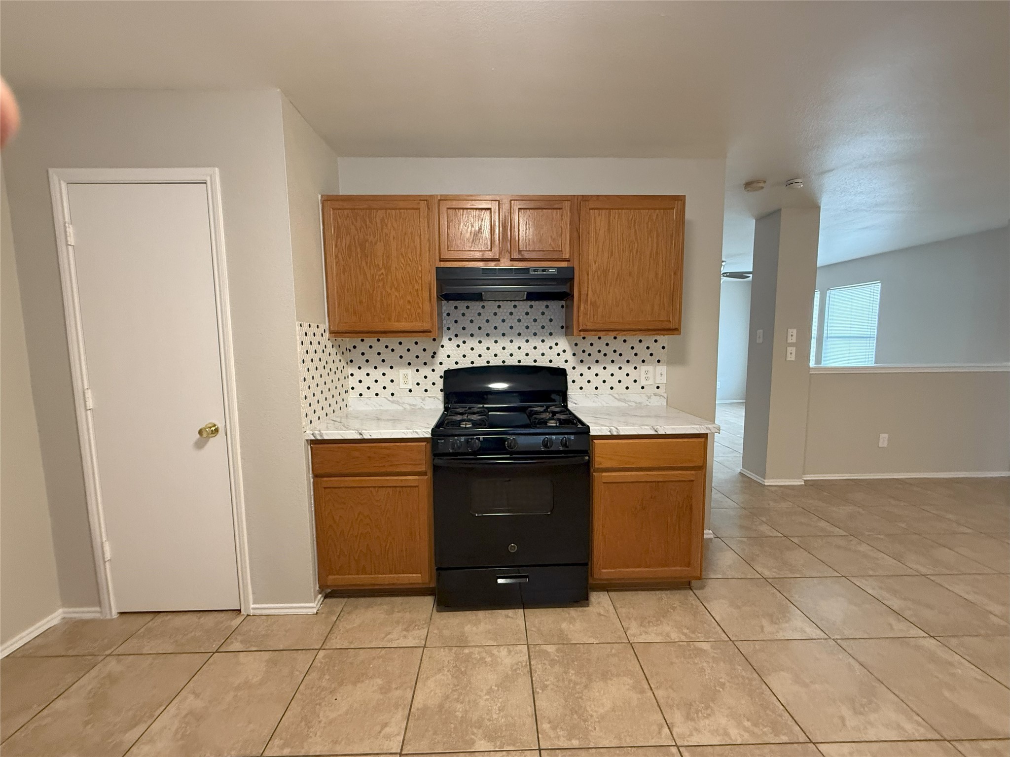 22819 Sugar Bear Drive Spring, TX 77389 - Photo 9 of 20 a kitchen with granite countertop a stove and a cabinets