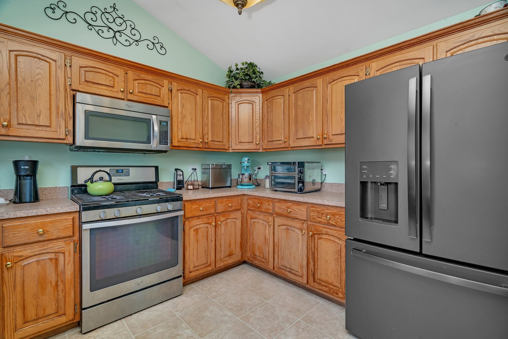 605 High Grove Drive Minooka, IL 60447 - Photo 13 of 42 a kitchen with stainless steel appliances granite countertop a refrigerator stove top oven and sink with dishwasher