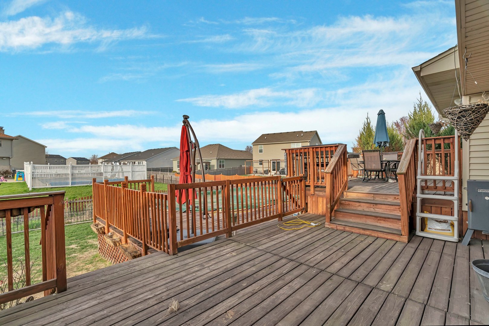 605 High Grove Drive Minooka, IL 60447 - Photo 38 of 42 a view of a balcony with wooden floor and iron fence