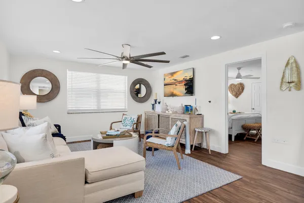 a bedroom with a bed and a flat tv screen on dresser